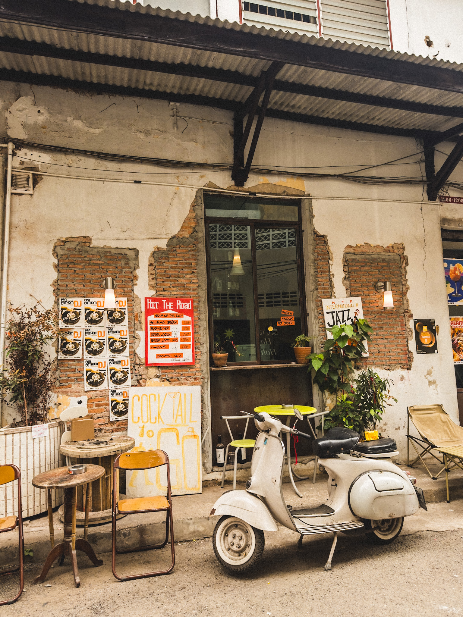 A scooter parked outside a café